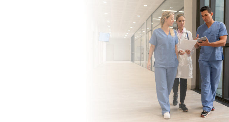 This is an image of doctors and nurses talking in a hallway.