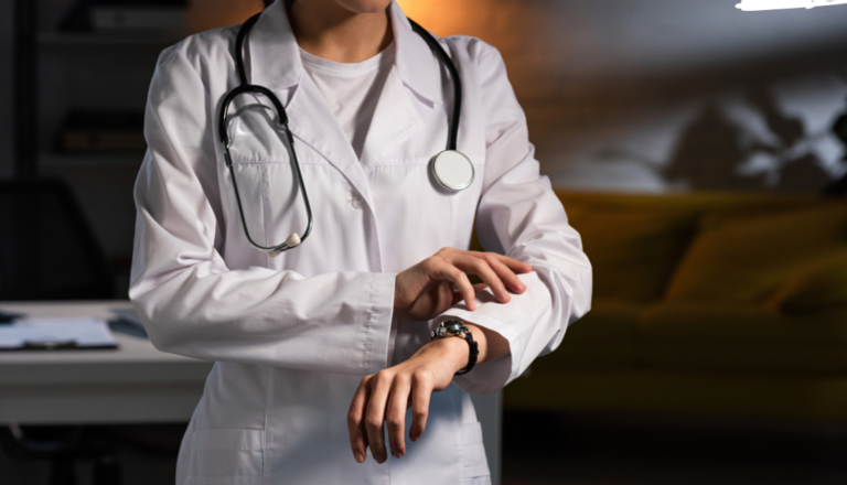 This is a picture of a doctor checking the time on their watch.