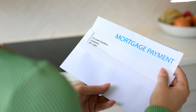 This is a picture of a person opening a mortgage payment bill.