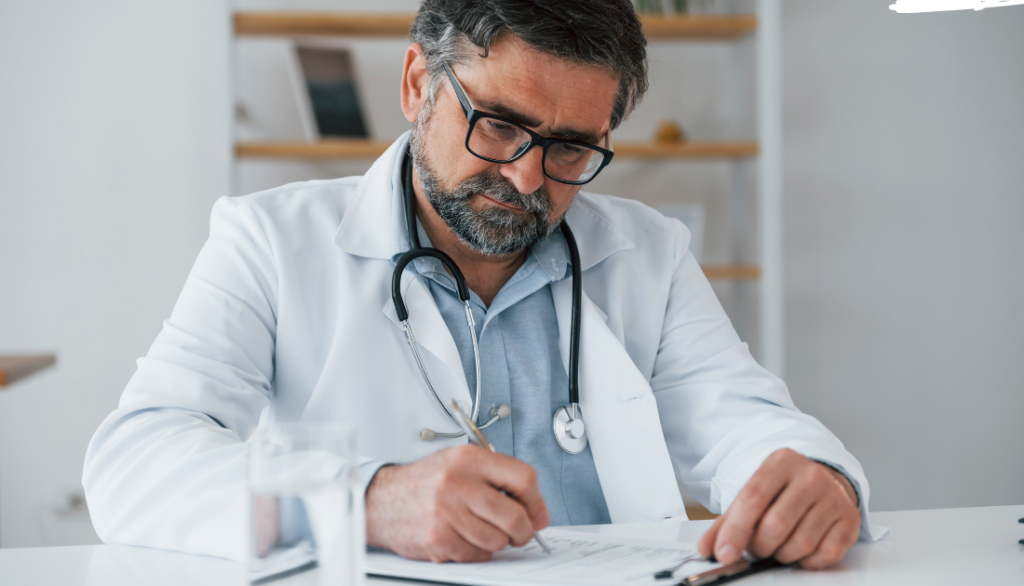 This is a doctor signing a piece of paper.
