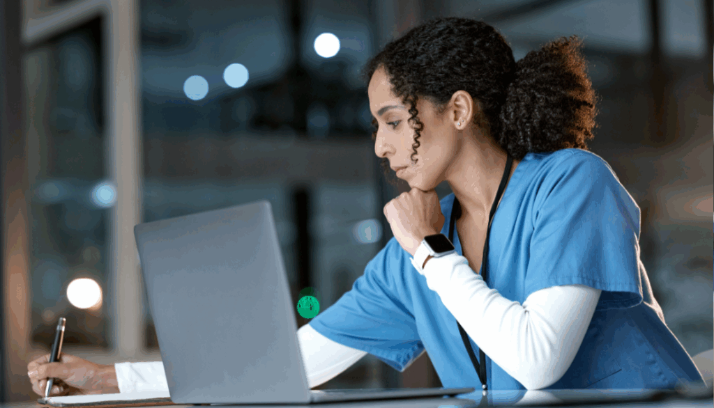 A doctor working on a computer.