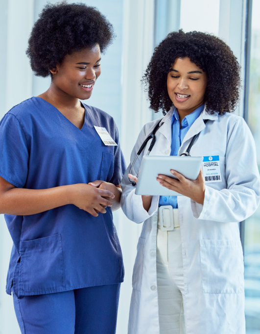 Two medical professionals looking at a tablet