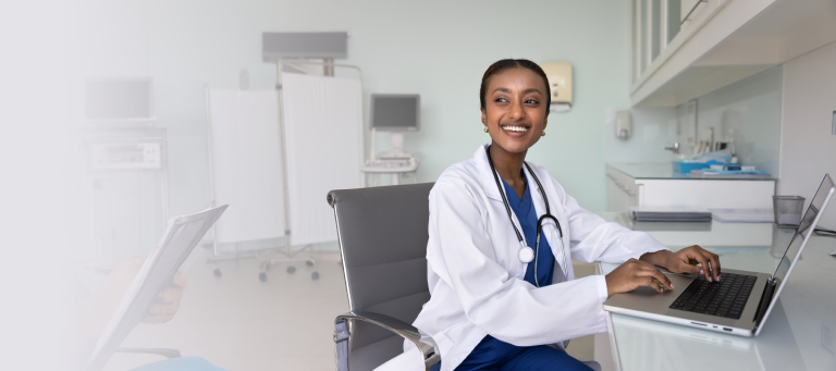 This is a smiling doctor at a desk.