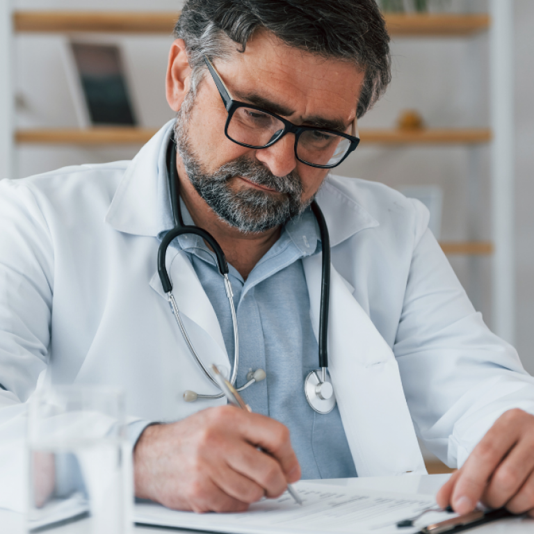 This is a doctor signing a piece of paper.