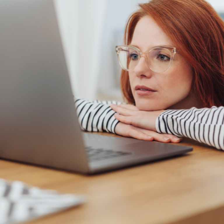 This is a photo of a girl looking at a computer screen.